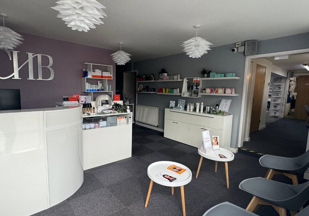 Interior view of a contemporary beauty salon showcasing shelves with skincare and beauty products, c.